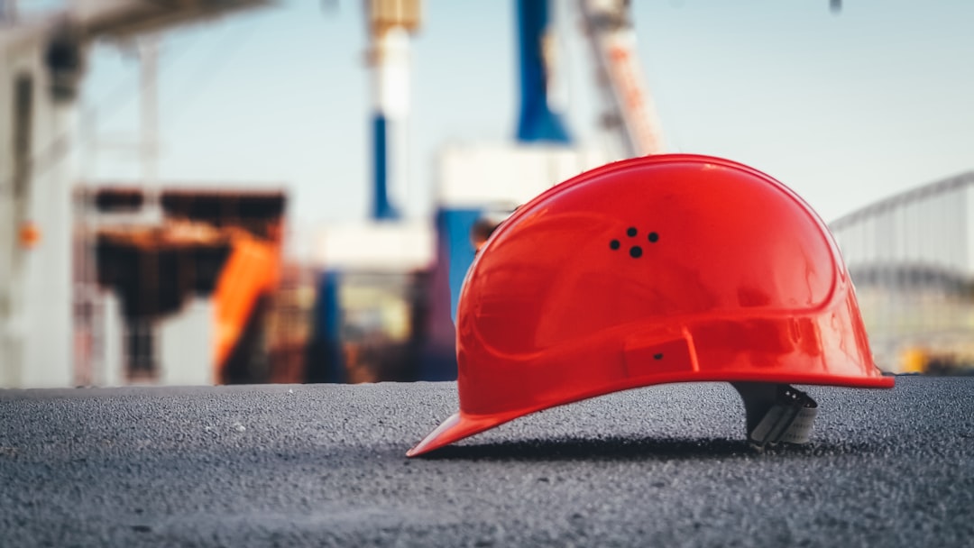 Illustration: red hard hat on pavement\